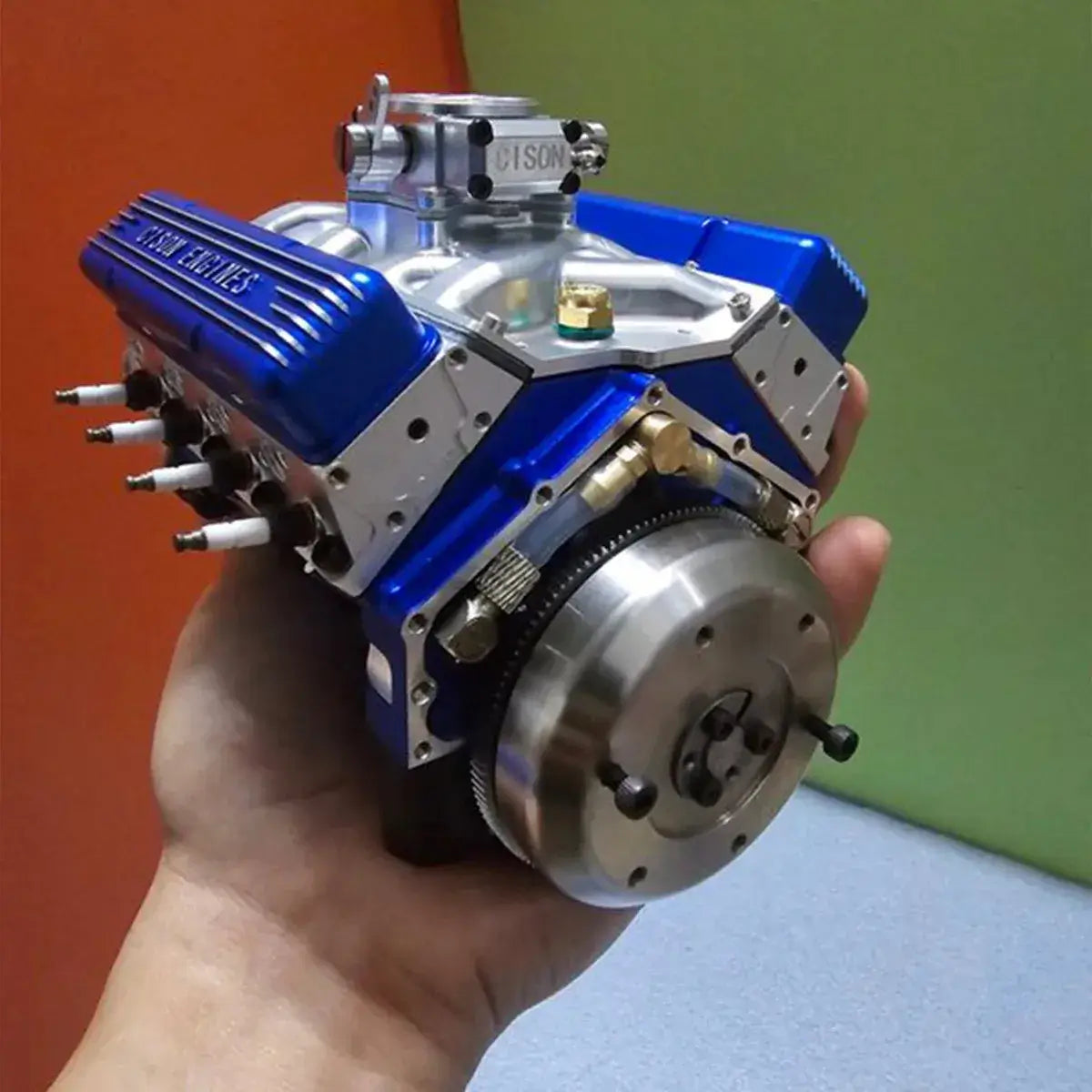 CISON metal mini V8 gas engine held in hand for visual scale comparison, weighing 1,700 grams