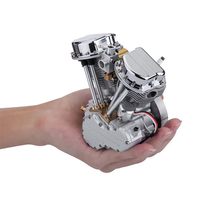 CISON working V-twin model engine shown handheld for size comparison and scale.