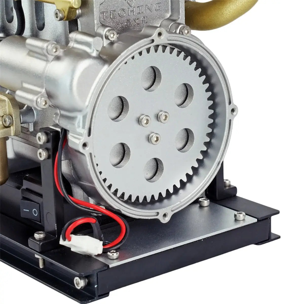 Close-up of TECHING L4 (4 cylinder) diesel model engine, showing CNC-machined aluminum flywheel.
