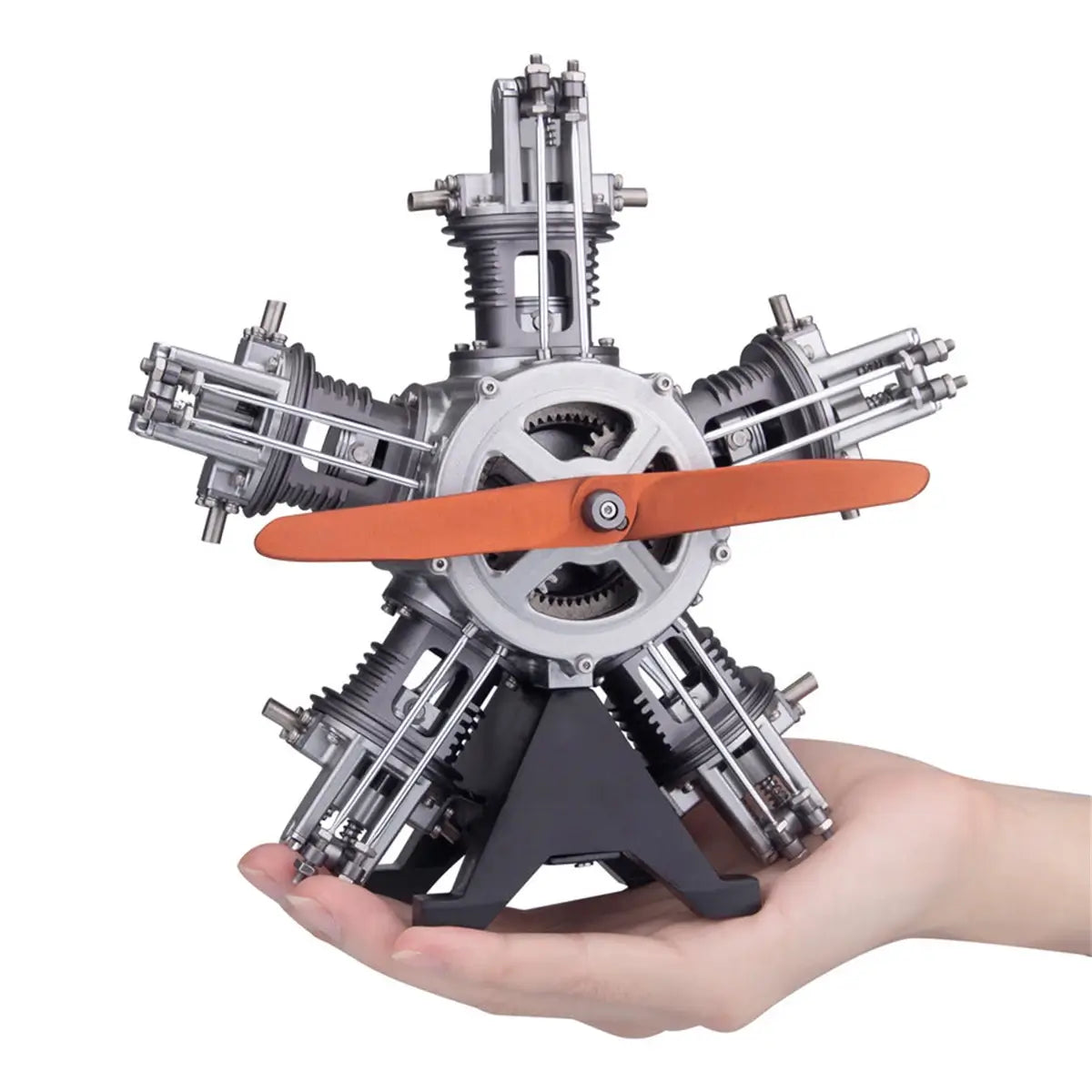 TECHING radial 5-cylinder model engine held in hand for scale reference and portability.