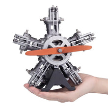 TECHING radial 5-cylinder model engine held in hand for scale reference and portability.