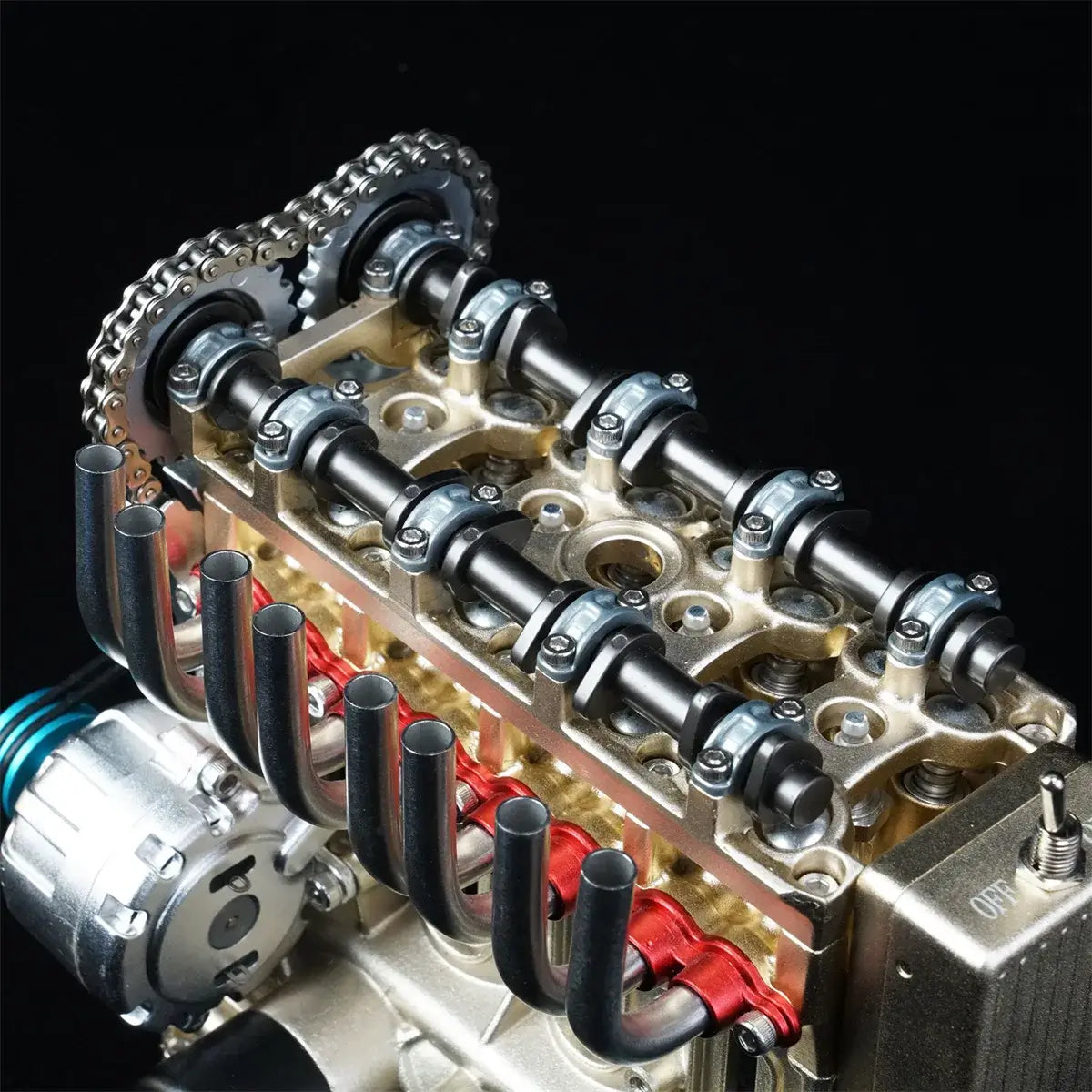 CNC-machined metal camshafts on TECHING miniature 4 cylinder engine for detailed engineering display.